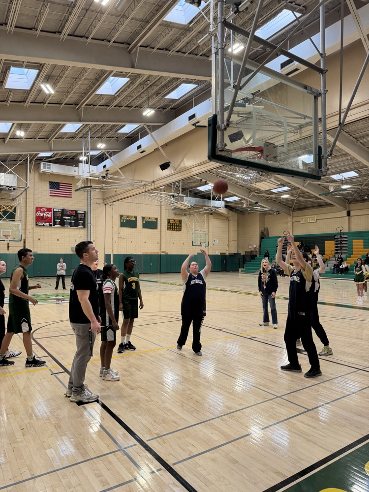 basketball player taking a jump shot from the foul line