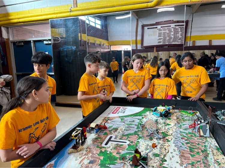 Team watching their robot do the work.