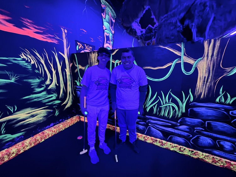 buddies taking picture together at mini golf course