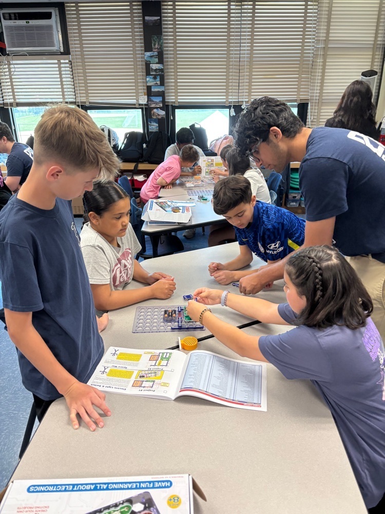 students working with high school students