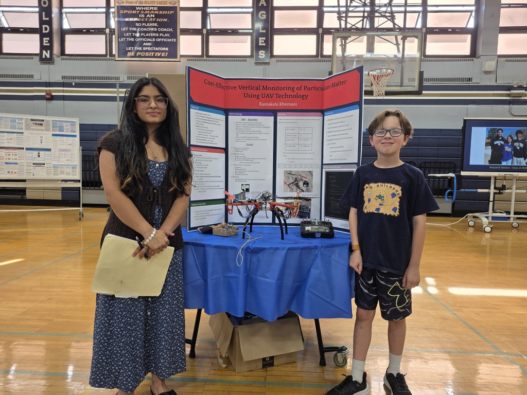 Kamakshi explains her research project to a Grade 5 student at the Bethpage High School Research Symposium