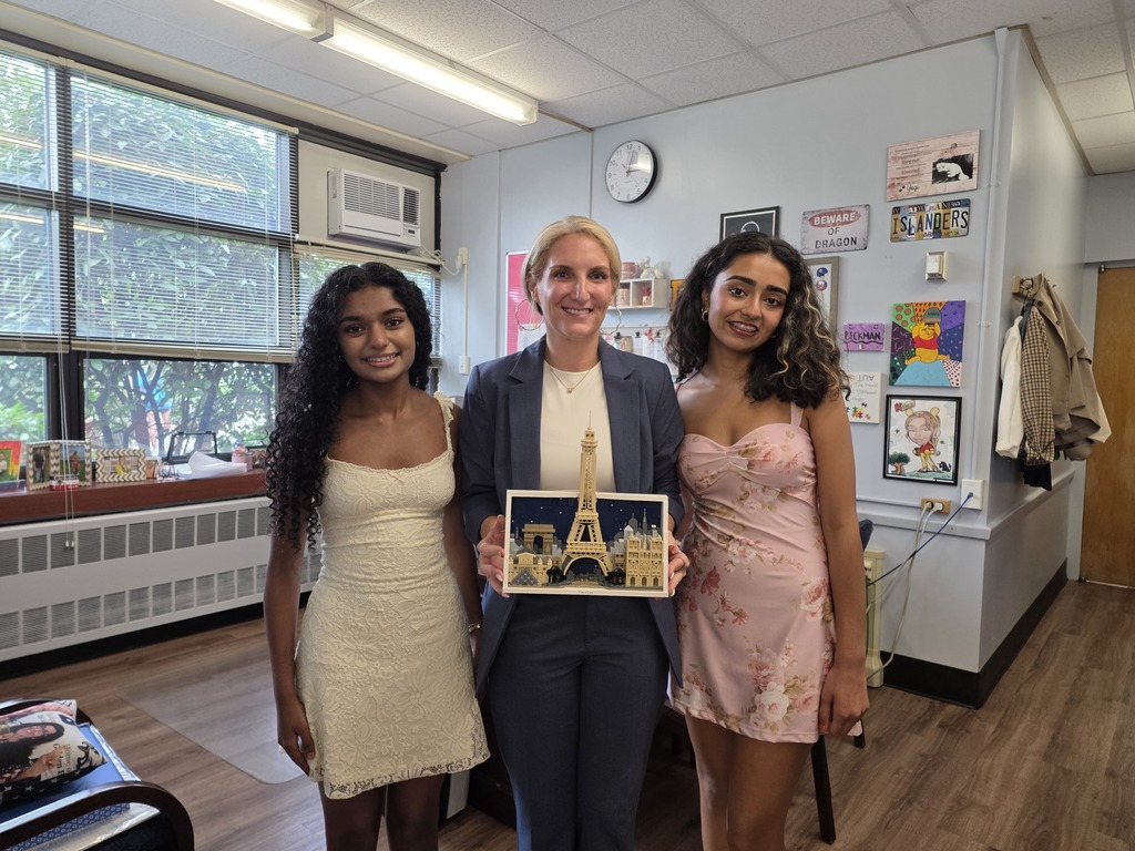 Theresa and Harsita present Ms. Hirsch Beckman with a Lego France piece