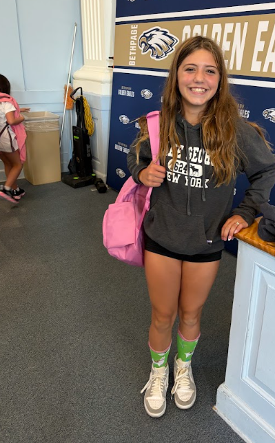6th Grade winner at assembly showing off her prize Llama socks