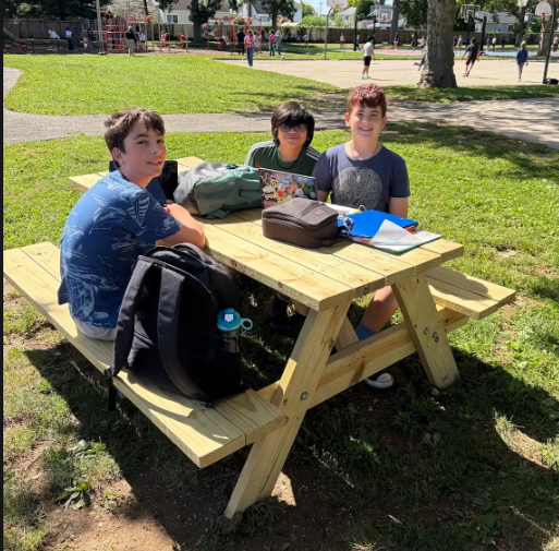 JFK studnets enjoying the new picnic table built by BHS Senior Jaskaran Minhas for his Eagle Scout Project