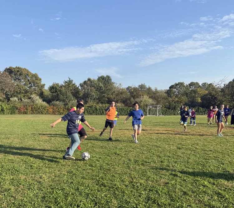 student dribbling between defenders