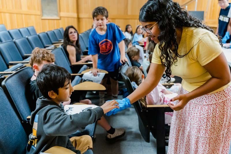 Students touching marine animal.