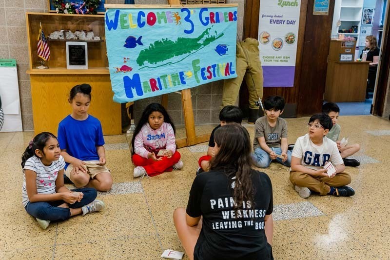 Students touching marine animal.