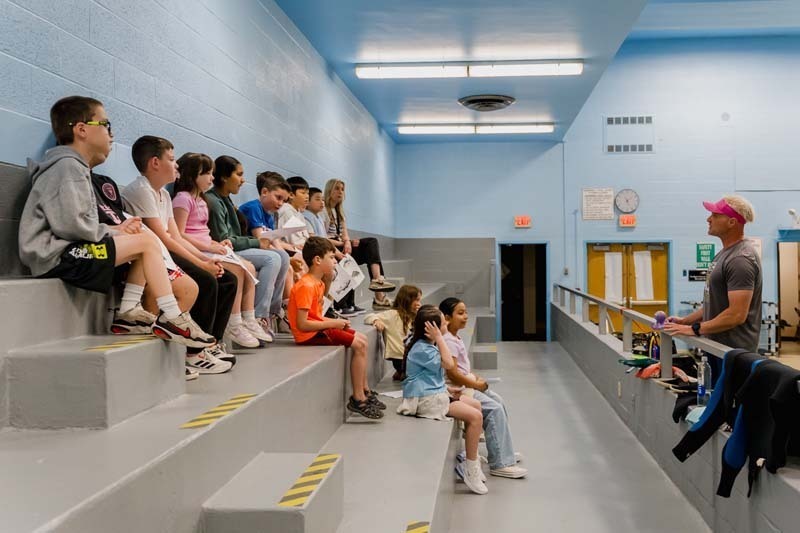 Students touching marine animal.