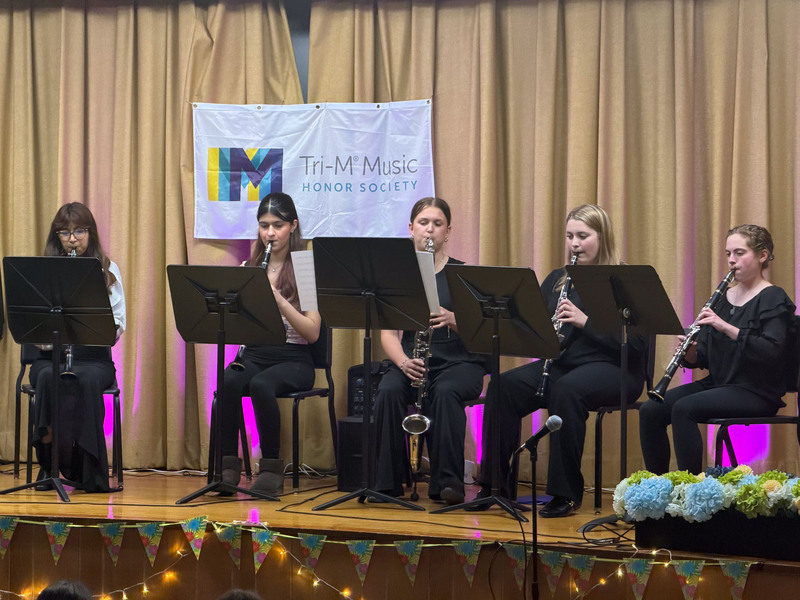 Students performing on stage.