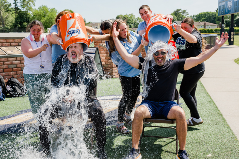 water pouring from buckets on participants