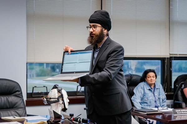 BHS junior demonstrates mind-controlled exoskeleton at board meeting