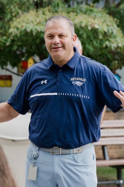Photo of man smiling outside.