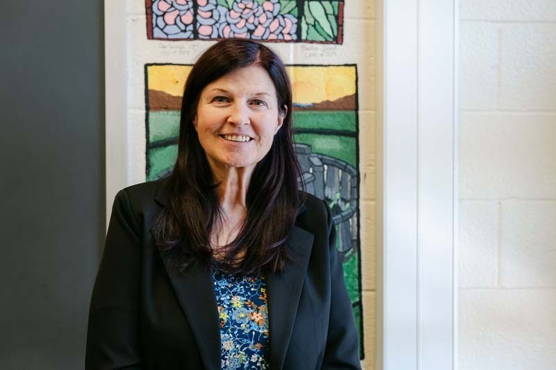 Photo of teacher sitting at desk.