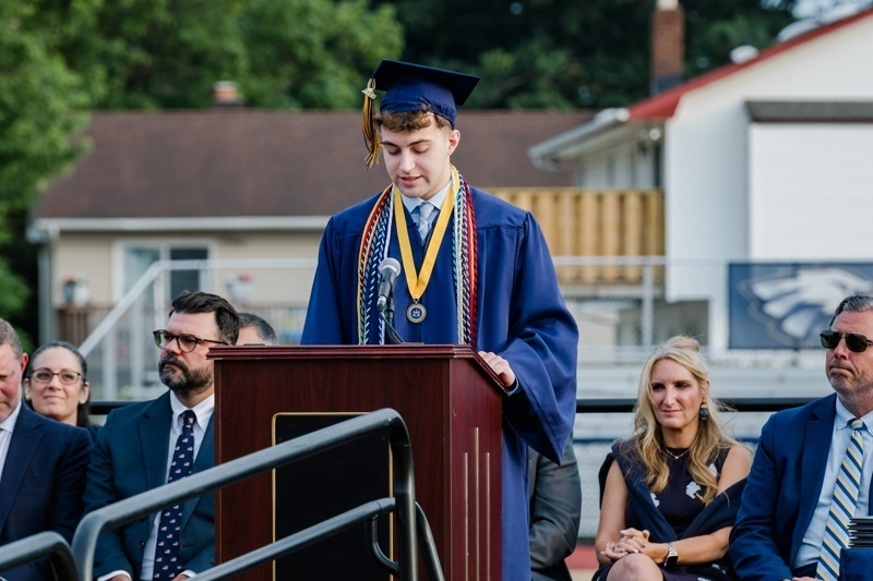 two graduates in blue caps and gowns