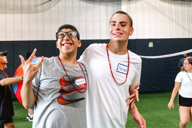 Two students smiling.