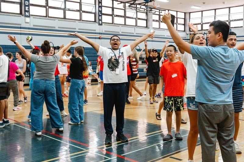 Students raising their hands in the air.
