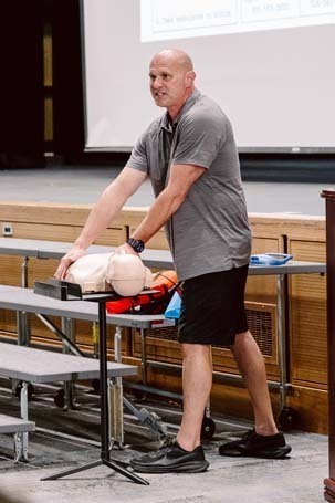 Man giving presentation on stage.