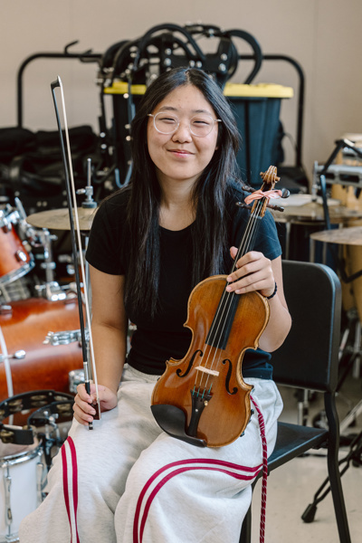 Person holding violin and bow