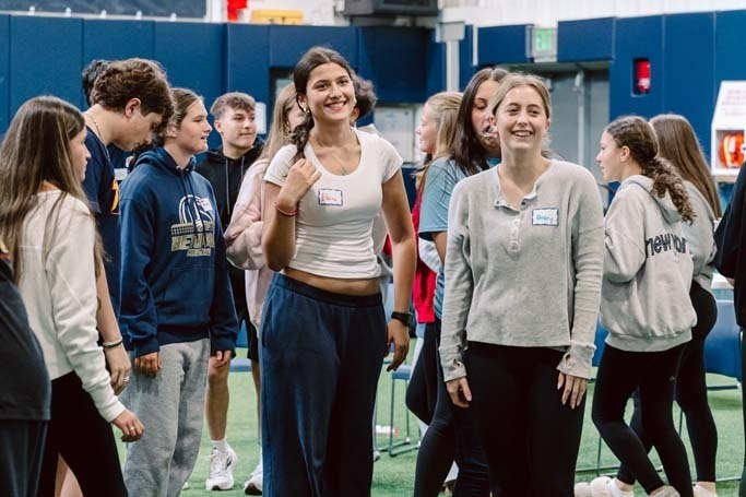 Students smiling in gymnasium.