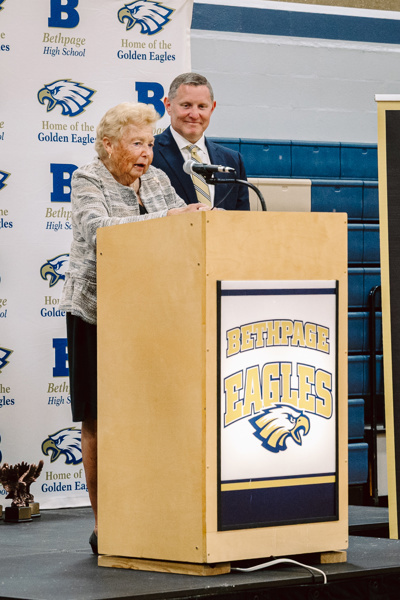 woman and man speaking at podium