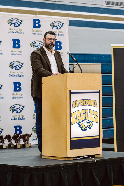 man speaking at podium