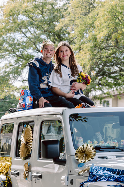 People sitting on a decorated car