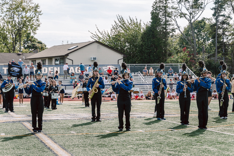 Marching band performing on football field
