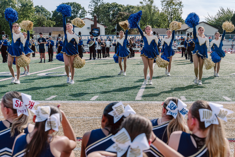 Cheerleaders performing with pom poms