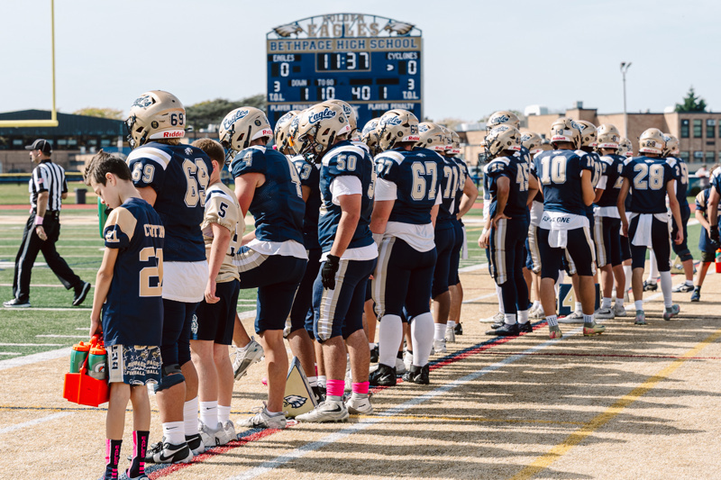 Football players on the sideline at stadium