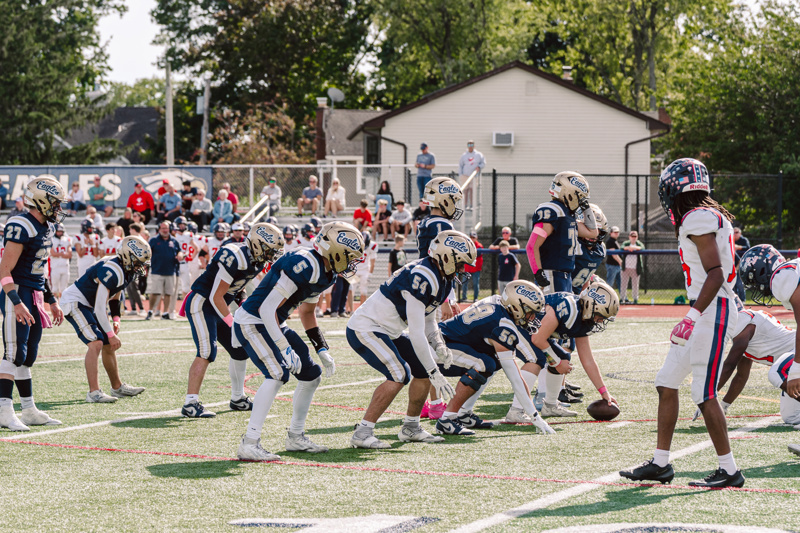 Football players on field preparing for play