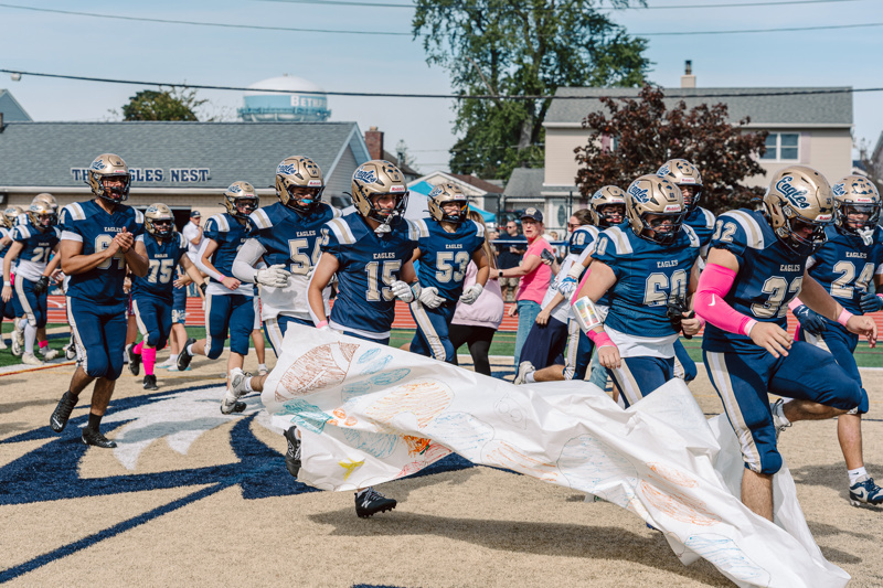 Football players running onto field