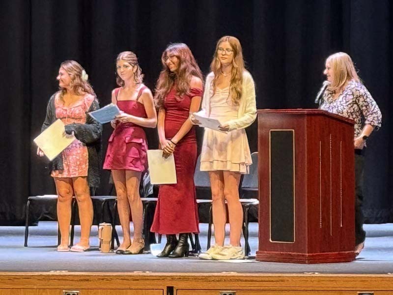 Students speaking on stage.