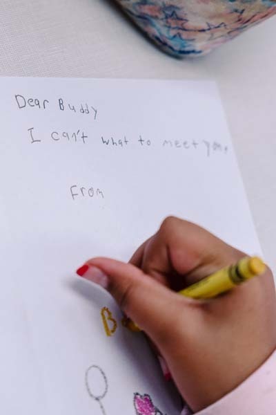 Student writing in library.