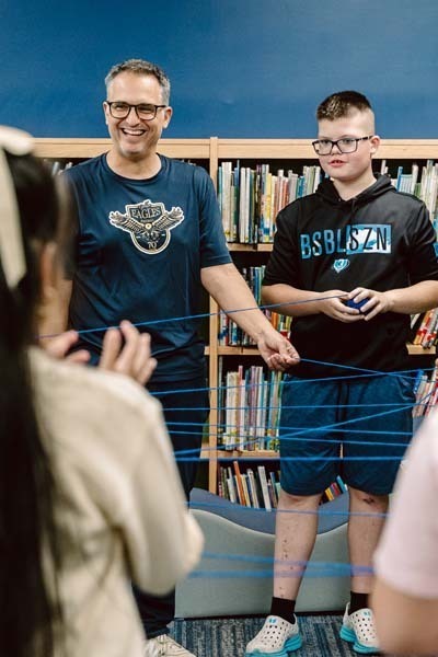 Student and teacher in library.