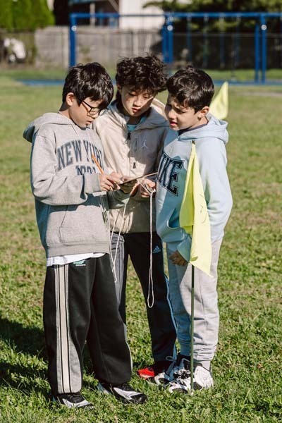 Students talking to each other on field.