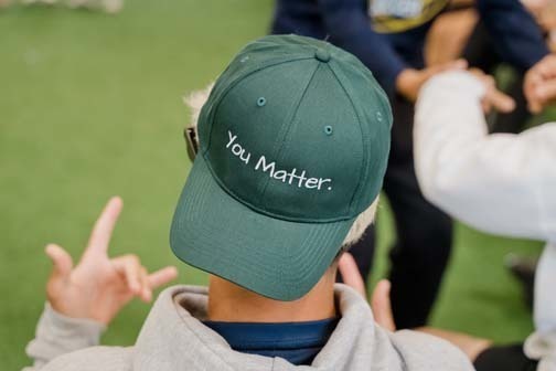 Student in green You Matter hat.