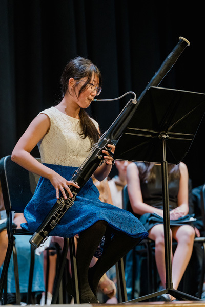 students on stage performing instruments