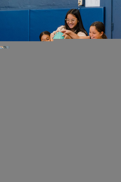 person being dressed in a costume by other people