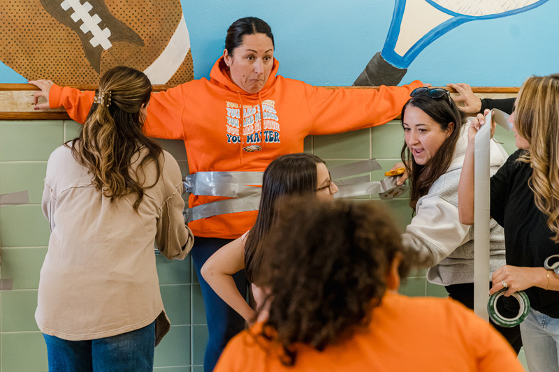 person being duct taped to wall