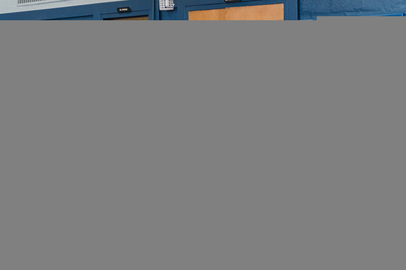 students sitting on floor in front of traffic cones