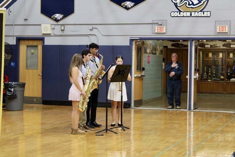 Students playing music in gymnasium.