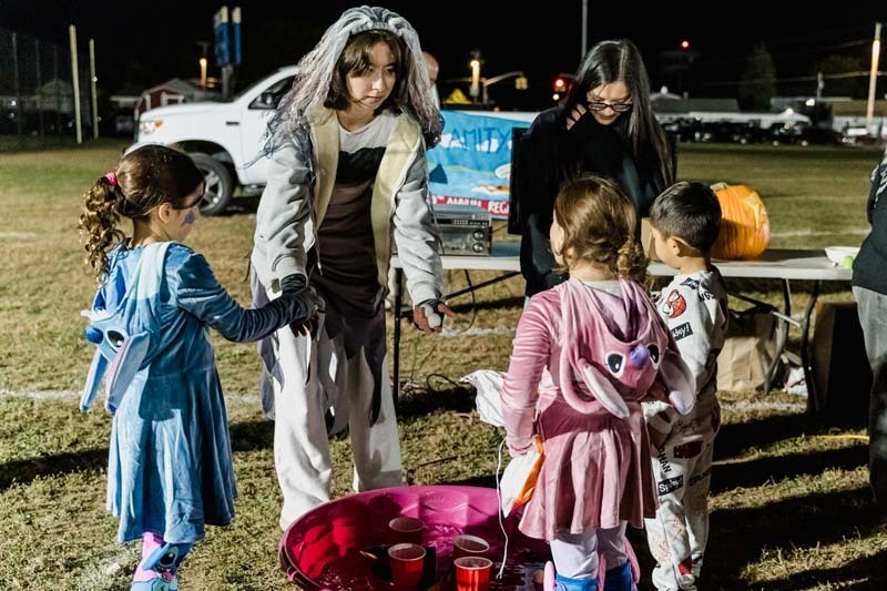 Students outside in Halloween costumes.