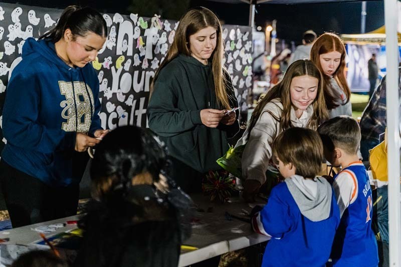 Students outside in Halloween costumes.
