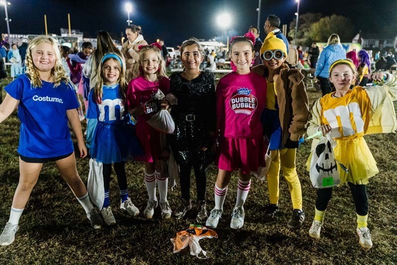 Students outside in Halloween costumes.