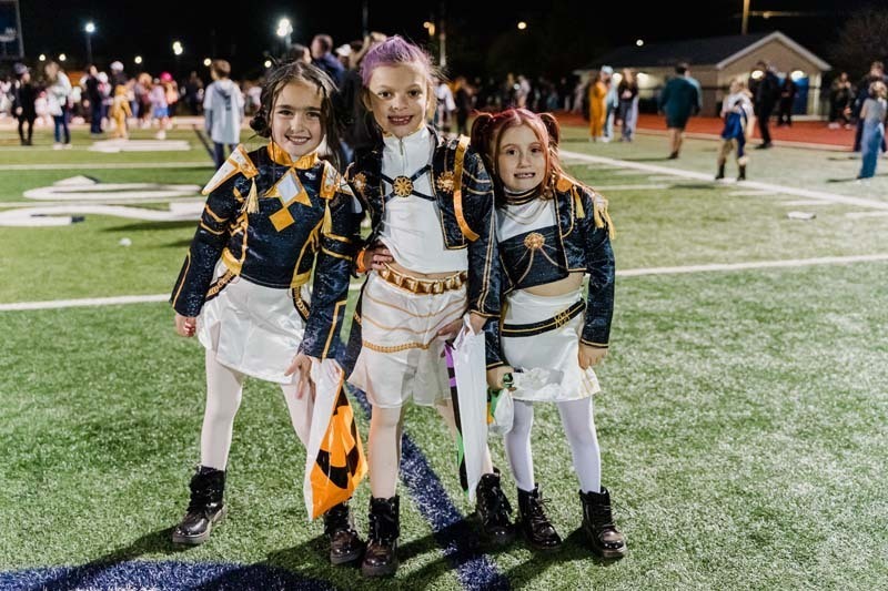 Students outside in Halloween costumes.
