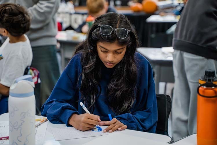 Students giving demonstration to younger kids.