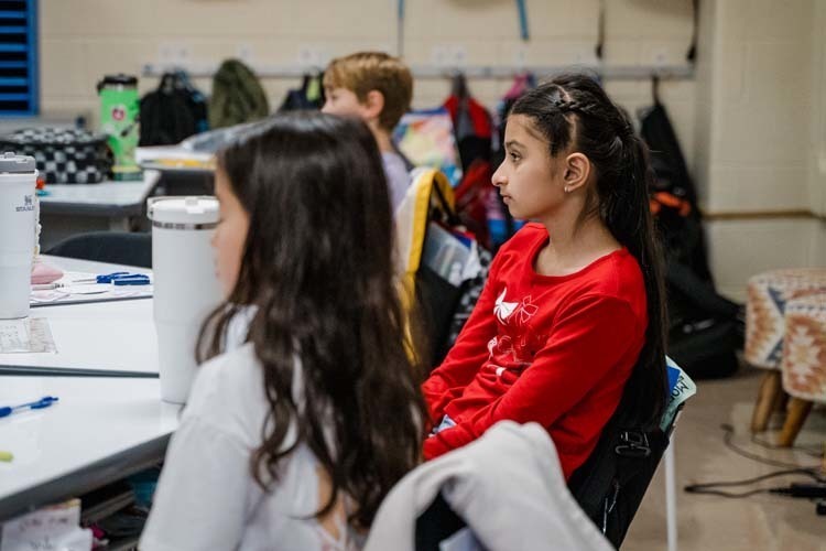 Students giving demonstration to younger kids.