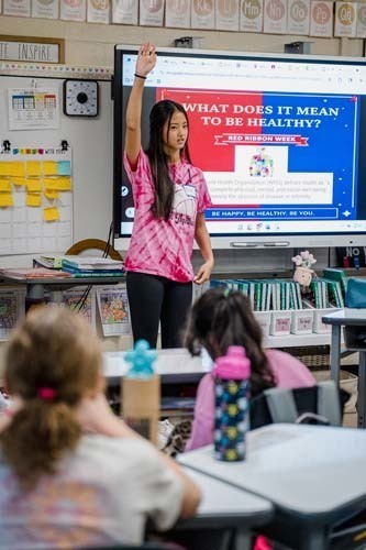 Students giving demonstration to younger kids.