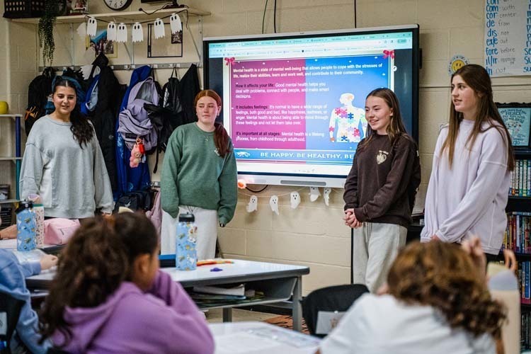 Students giving demonstration to younger kids.