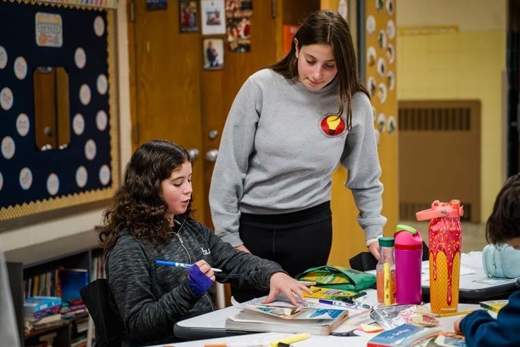 Students giving demonstration to younger kids.